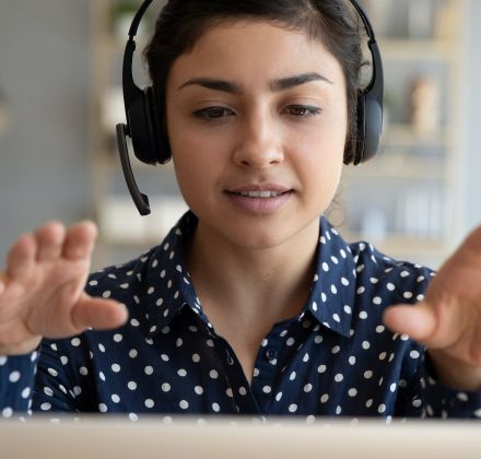 A woman wearing a telephone headset