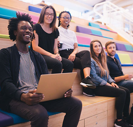 A group of young professionals seated in a lecture theatre